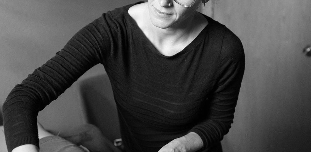 Therapist providing foot massage in a calm setting.