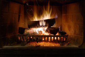 Fireplace with burning logs and flames.